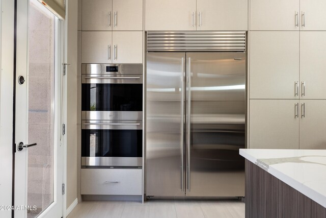 kitchen featuring light stone counters and appliances with stainless steel finishes