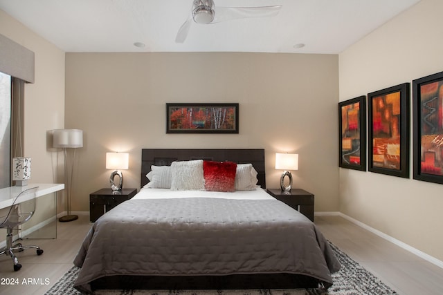 tiled bedroom with ceiling fan and baseboards