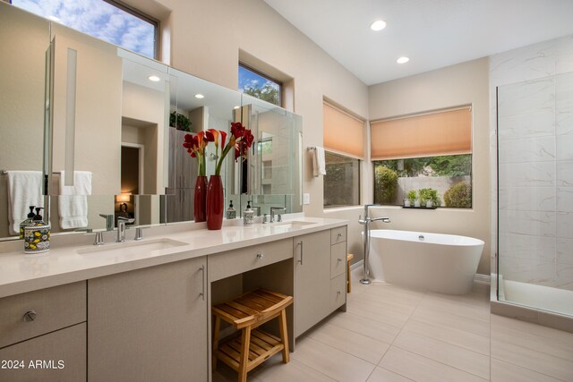 bathroom with tile patterned flooring, vanity, and separate shower and tub