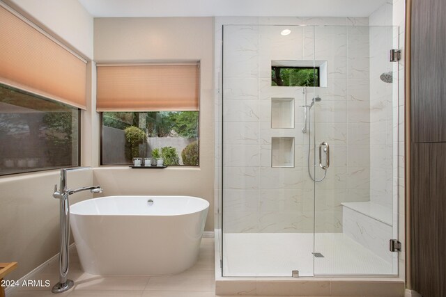 bathroom featuring plus walk in shower and tile patterned flooring