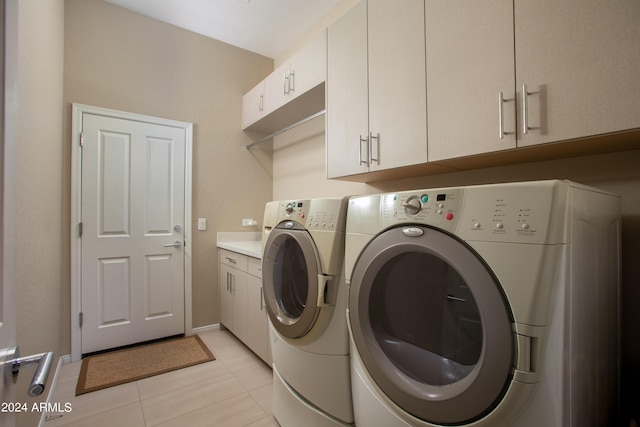 clothes washing area featuring cabinet space, baseboards, separate washer and dryer, and light tile patterned flooring