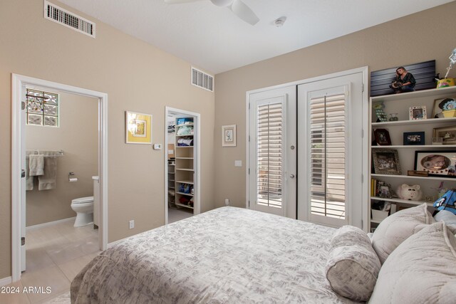 tiled bedroom with french doors, a closet, a spacious closet, access to outside, and ceiling fan