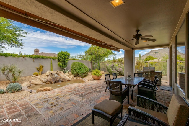 view of patio / terrace with ceiling fan, outdoor dining space, and a fenced backyard