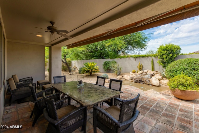 view of patio / terrace featuring a ceiling fan, outdoor dining area, and a fenced backyard