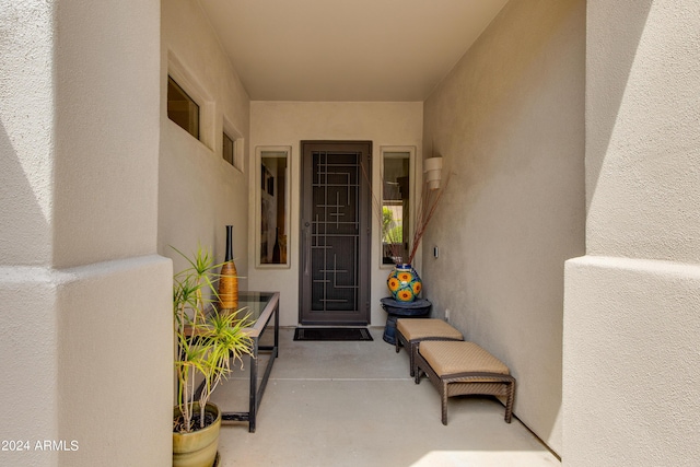 property entrance with a patio and stucco siding