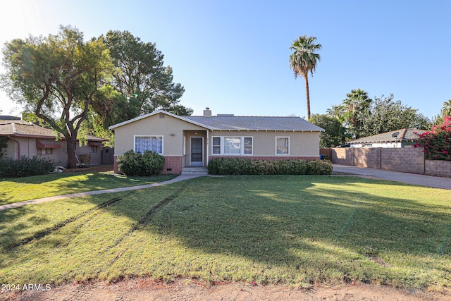 ranch-style house featuring a front lawn