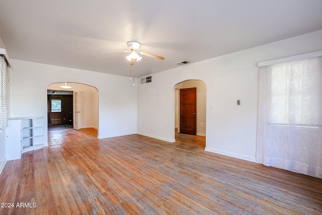 unfurnished room with light wood-type flooring and ceiling fan