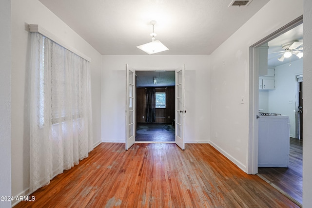 spare room with ceiling fan and hardwood / wood-style flooring