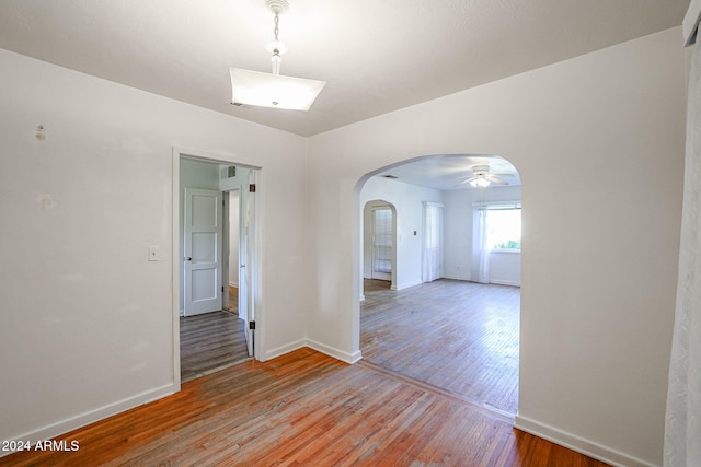 spare room featuring light wood-type flooring and ceiling fan