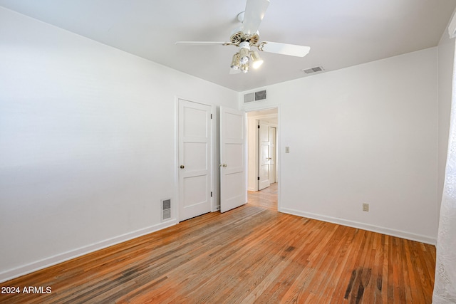 spare room with light wood-type flooring and ceiling fan