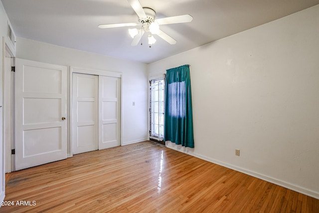 unfurnished bedroom with a closet, light hardwood / wood-style floors, and ceiling fan