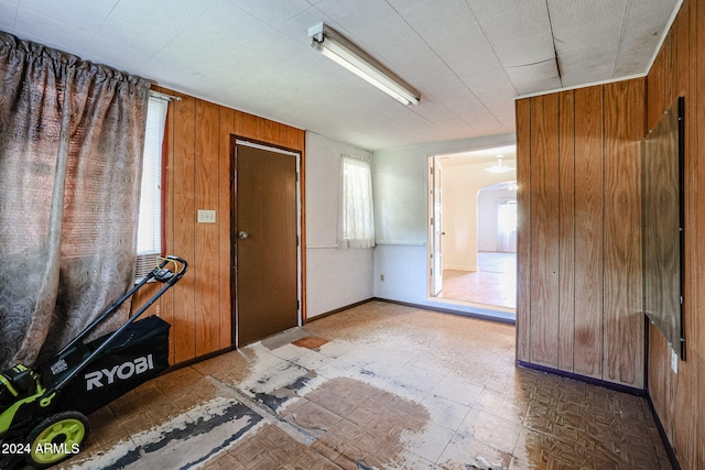 entryway with wood walls