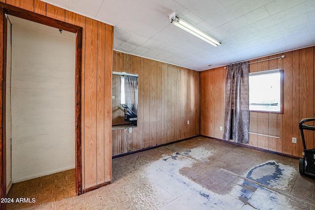 unfurnished room with wooden walls