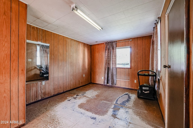 unfurnished room with wood walls