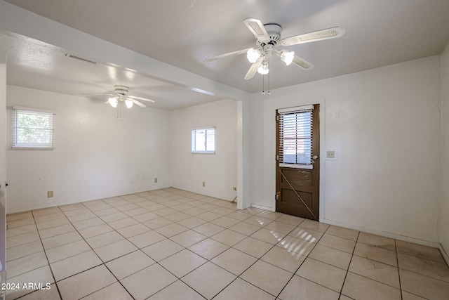 tiled empty room with ceiling fan