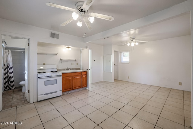 kitchen featuring white range, sink, ceiling fan, and light tile patterned floors