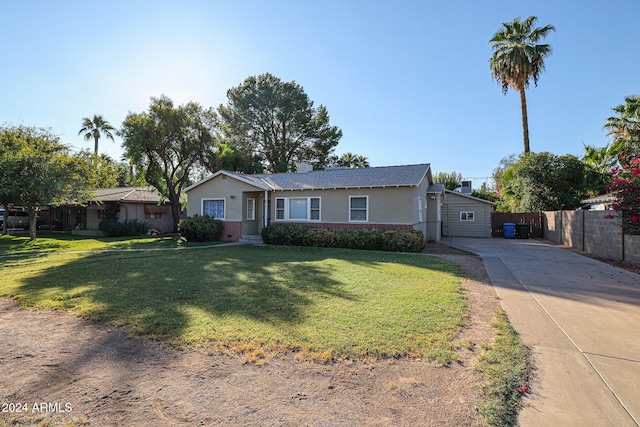 single story home with a front yard