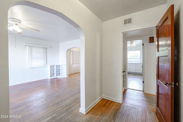 hallway with hardwood / wood-style flooring