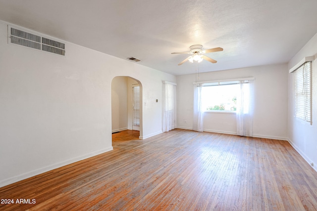 spare room featuring light hardwood / wood-style flooring and ceiling fan