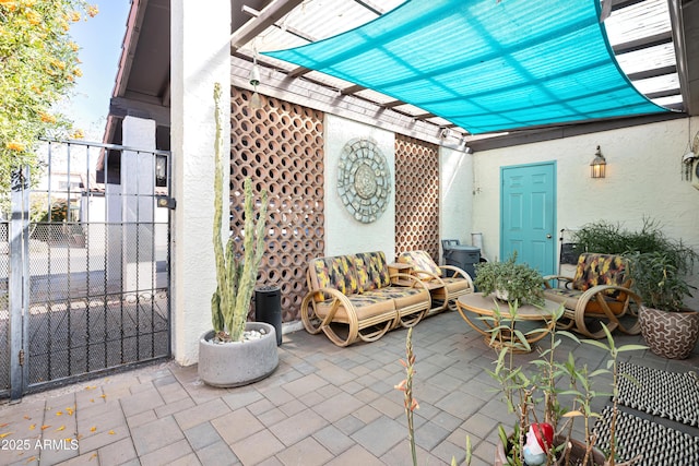 view of patio featuring fence and a gate