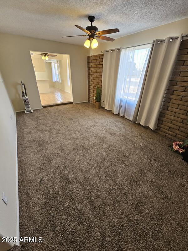 interior space featuring a textured ceiling and carpet flooring