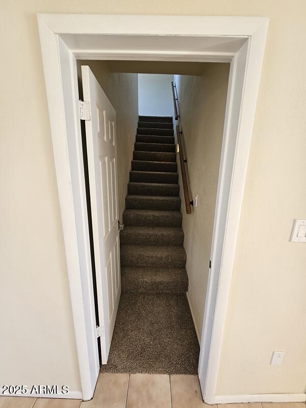 stairway featuring tile patterned floors