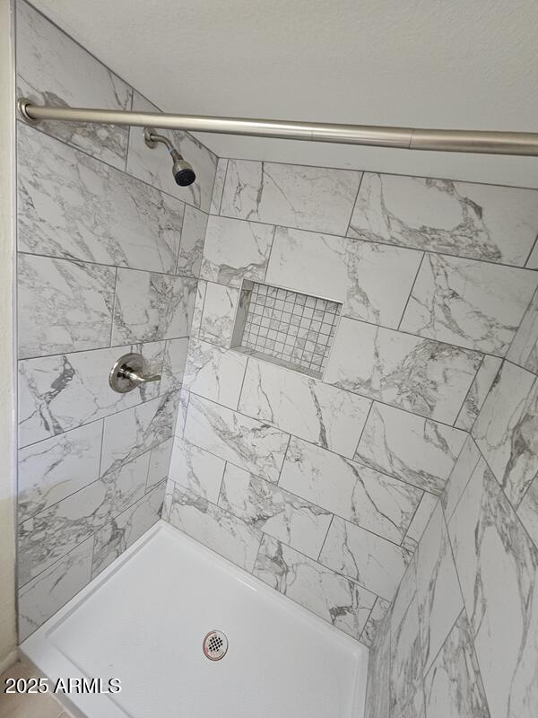 full bath featuring a shower stall