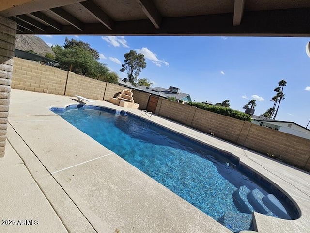 view of swimming pool with a diving board, a patio area, a fenced backyard, and a fenced in pool