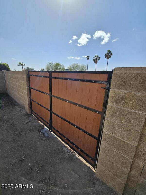 view of gate featuring fence