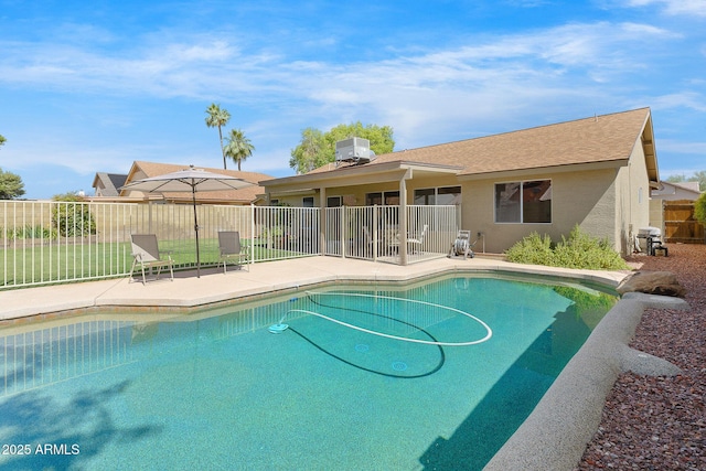 view of swimming pool featuring a patio area, fence, and cooling unit