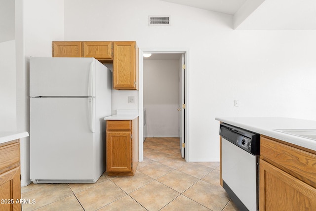 kitchen featuring white appliances, light countertops, and light tile patterned floors