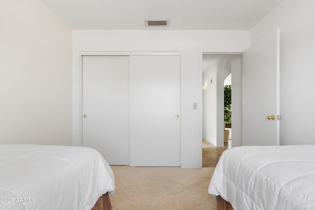 carpeted bedroom featuring a closet
