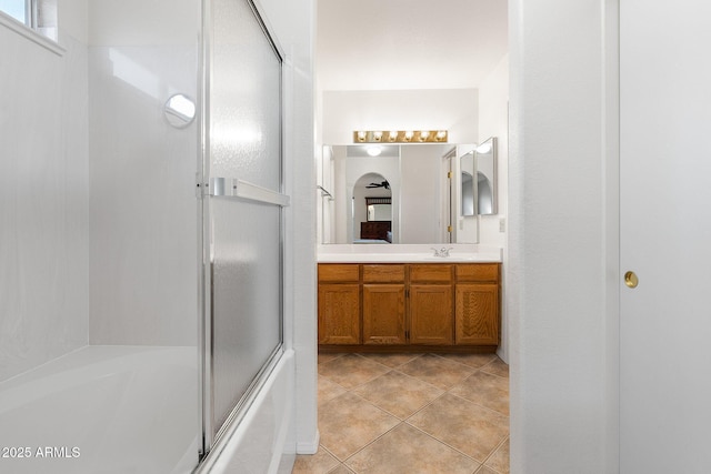 bathroom featuring vanity, bath / shower combo with glass door, and tile patterned floors