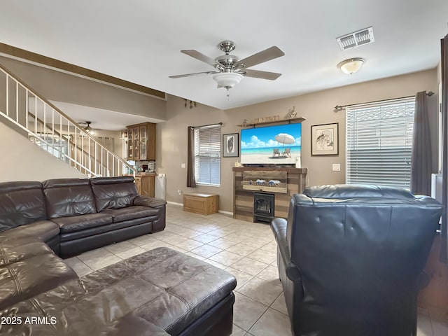 tiled living room featuring ceiling fan