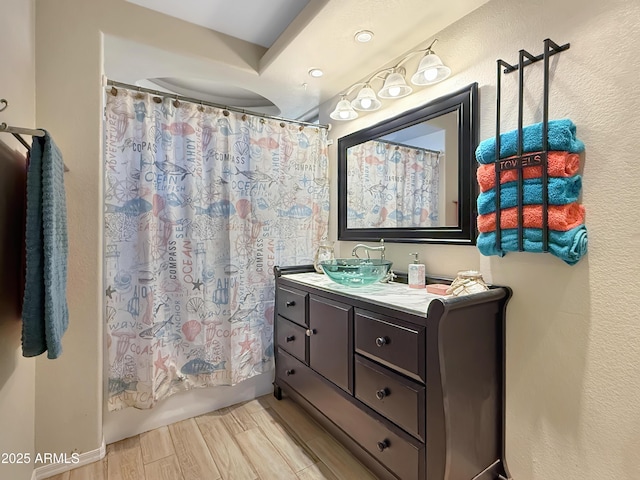 bathroom with shower / bathtub combination with curtain and vanity