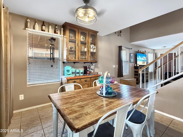 dining area featuring ceiling fan, light tile patterned floors, and plenty of natural light