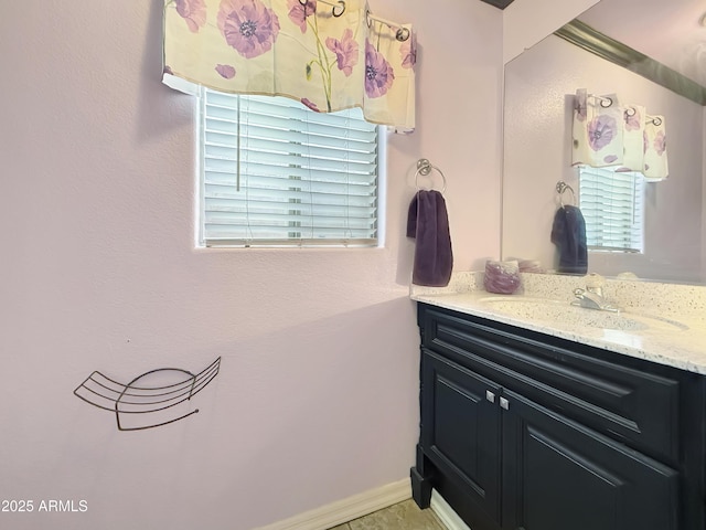 bathroom with plenty of natural light and vanity