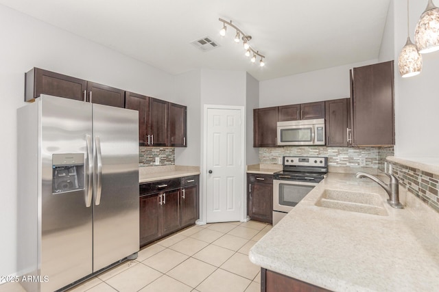 520 E Townley Ave, Phoenix, AZ 85020 - kitchen with backsplash, dark brown cabinets, visible vents, a sink, and appliances with stainless steel finishes