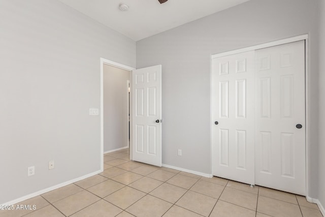 520 E Townley Ave, Phoenix, AZ 85020 - unfurnished bedroom with baseboards, a closet, and light tile patterned floors