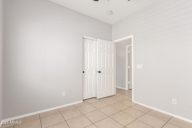 520 E Townley Ave, Phoenix, AZ 85020 - unfurnished bedroom with baseboards, a closet, ceiling fan, and light tile patterned flooring
