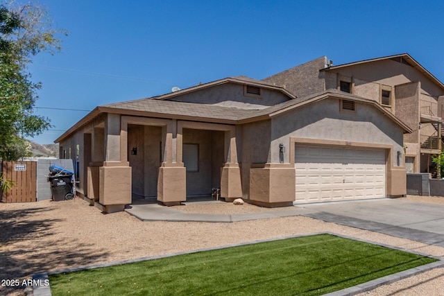 520 E Townley Ave, Phoenix, AZ 85020 - view of front of house featuring concrete driveway, an attached garage, fence, and stucco siding
