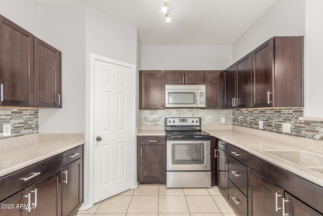 520 E Townley Ave, Phoenix, AZ 85020 - kitchen with light tile patterned floors, dark brown cabinets, appliances with stainless steel finishes, and tasteful backsplash