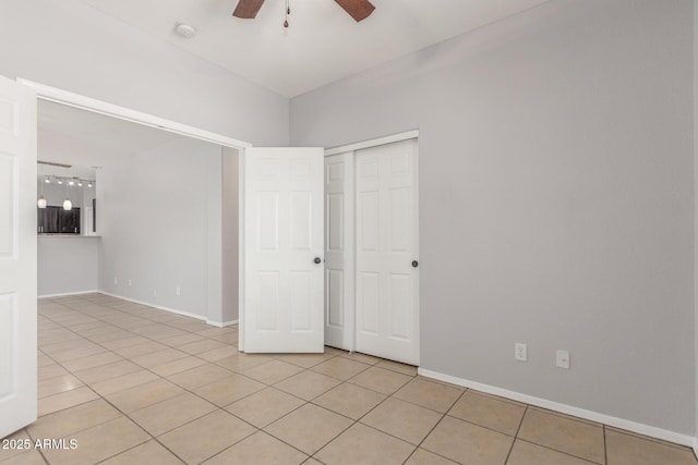 520 E Townley Ave, Phoenix, AZ 85020 - unfurnished bedroom with a closet, baseboards, ceiling fan, and light tile patterned floors