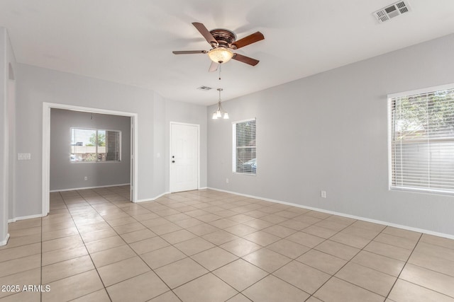 520 E Townley Ave, Phoenix, AZ 85020 - spare room with baseboards, ceiling fan with notable chandelier, visible vents, and light tile patterned floors