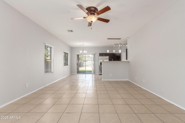 520 E Townley Ave, Phoenix, AZ 85020 - unfurnished living room with ceiling fan with notable chandelier, baseboards, visible vents, and light tile patterned flooring