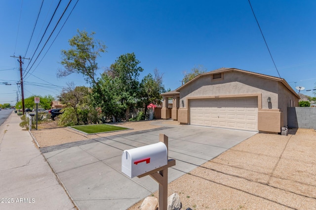 520 E Townley Ave, Phoenix, AZ 85020 - ranch-style home with stucco siding, concrete driveway, and a garage