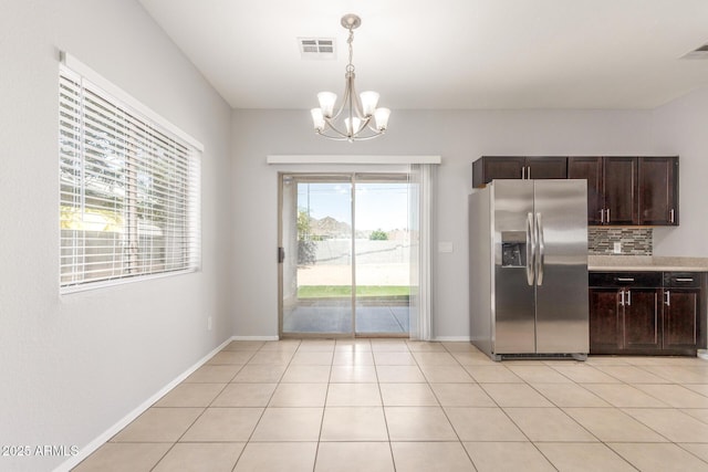 520 E Townley Ave, Phoenix, AZ 85020 - kitchen with an inviting chandelier, light countertops, pendant lighting, dark brown cabinetry, and stainless steel refrigerator with ice dispenser