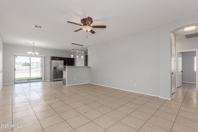 520 E Townley Ave, Phoenix, AZ 85020 - unfurnished living room with ceiling fan with notable chandelier, visible vents, arched walkways, and light tile patterned floors