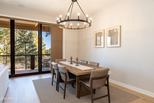 dining room featuring wood-type flooring and a notable chandelier