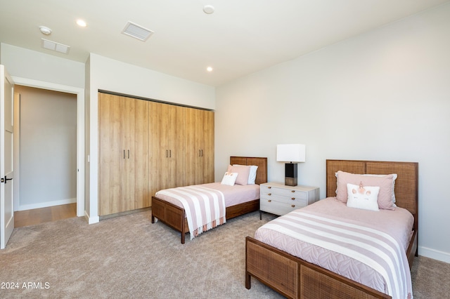 bedroom with a closet and light colored carpet